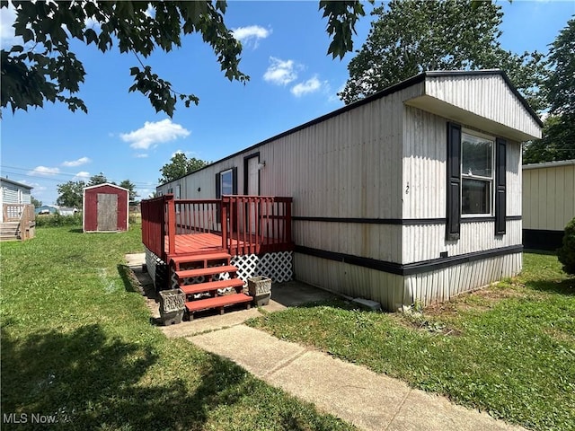 152 N Main St Unit 2, New London, OH 44851 - view of home's exterior with a deck, a yard, and a storage shed
