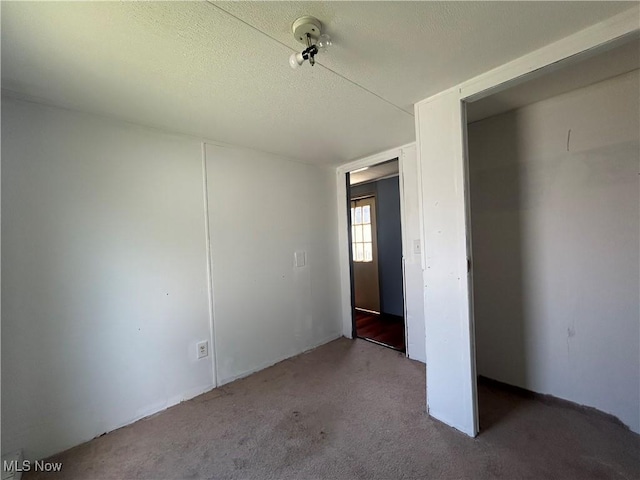 152 N Main St Unit 2, New London, OH 44851 - unfurnished bedroom featuring carpet floors and a textured ceiling