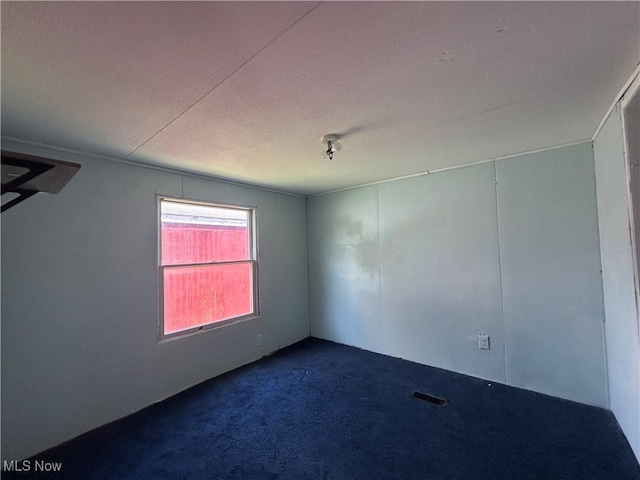 152 N Main St Unit 2, New London, OH 44851 - empty room with dark carpet and a textured ceiling