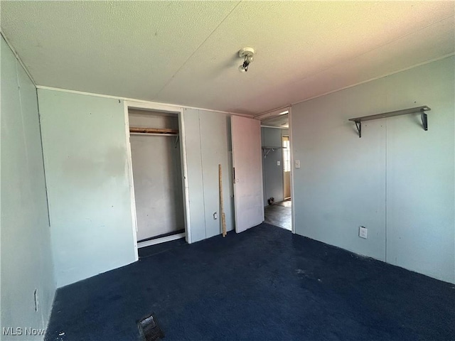 152 N Main St Unit 2, New London, OH 44851 - unfurnished bedroom with a closet, a textured ceiling, and carpet flooring