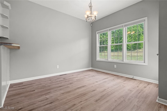 4428 Trail Head Cir NW, Massillon, OH 44647 - spare room featuring a chandelier and wood finished floors