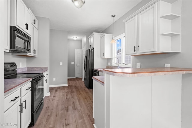 4428 Trail Head Cir NW, Massillon, OH 44647 - kitchen with black appliances, a peninsula, open shelves, light wood finished floors, and light countertops