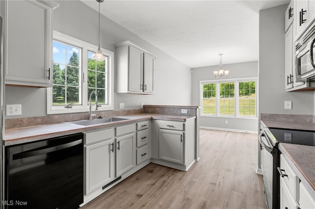 4428 Trail Head Cir NW, Massillon, OH 44647 - kitchen featuring dishwasher, electric range, light wood-style flooring, stainless steel microwave, and hanging light fixtures