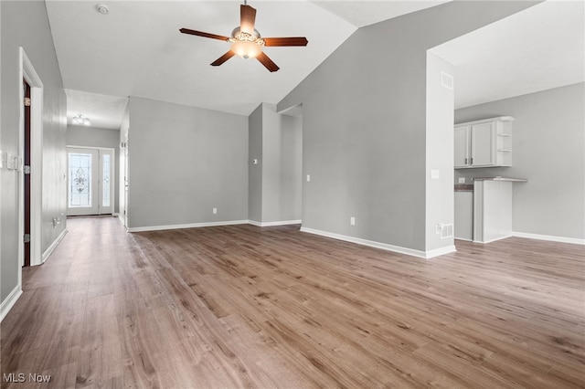 4428 Trail Head Cir NW, Massillon, OH 44647 - unfurnished living room with a ceiling fan, lofted ceiling, and light wood-style flooring