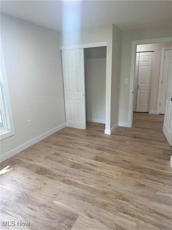 9822 Hooper Rd, Athens, OH 45701 - unfurnished bedroom with light wood-type flooring and a closet