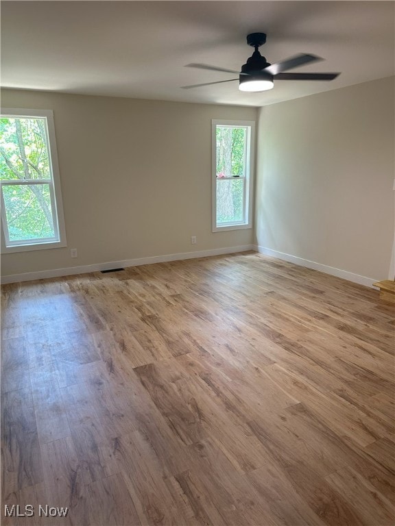 9822 Hooper Rd, Athens, OH 45701 - empty room featuring healthy amount of natural light, ceiling fan, and wood finished floors