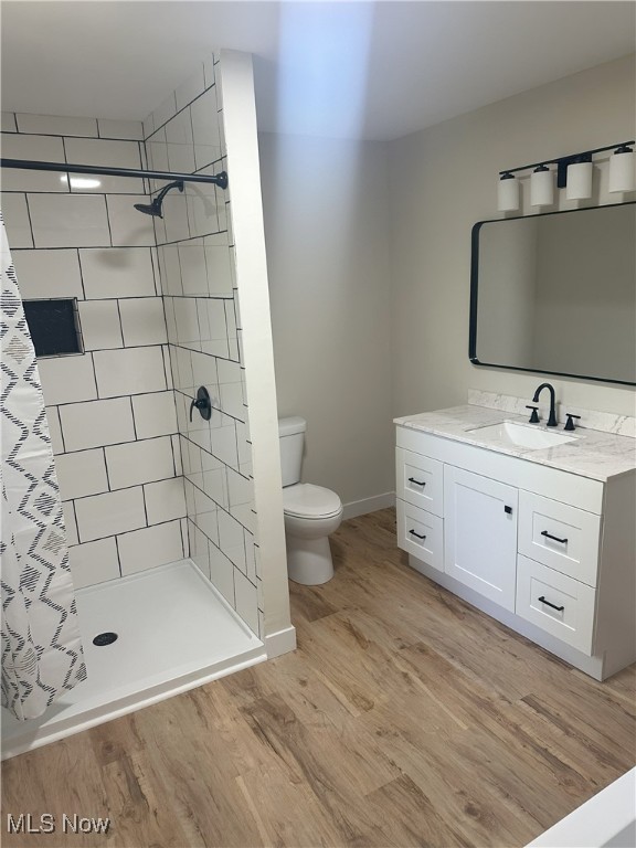 9822 Hooper Rd, Athens, OH 45701 - bathroom featuring wood finished floors, vanity, and a tile shower