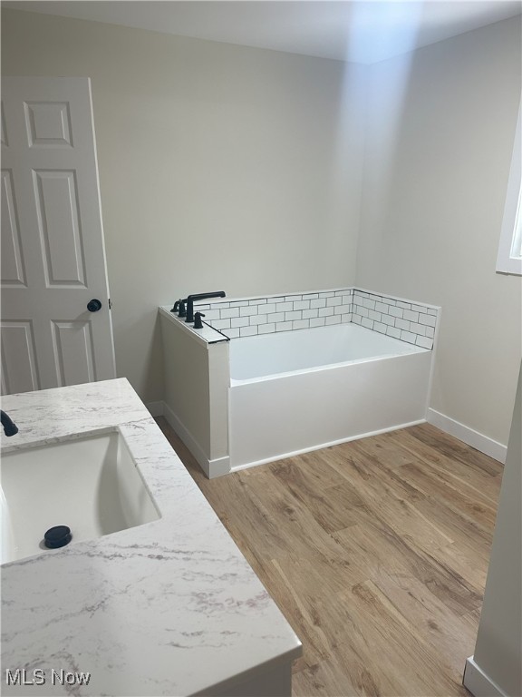 9822 Hooper Rd, Athens, OH 45701 - bathroom with a garden tub and wood finished floors