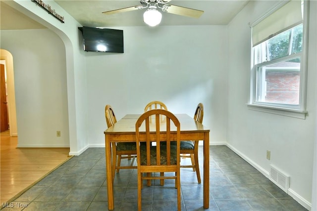 131 Euclid Blvd, Youngstown, OH 44505 - dining room with arched walkways, a ceiling fan, and dark tile patterned floors
