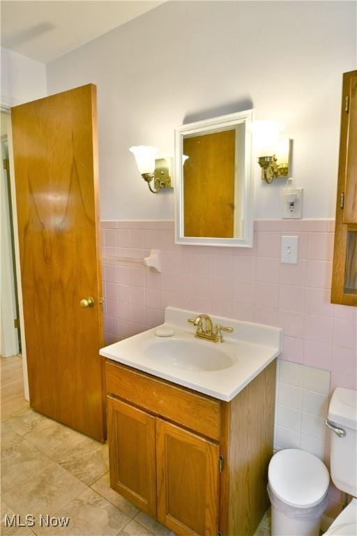 131 Euclid Blvd, Youngstown, OH 44505 - bathroom with tile walls, vanity, wainscoting, and tile patterned flooring
