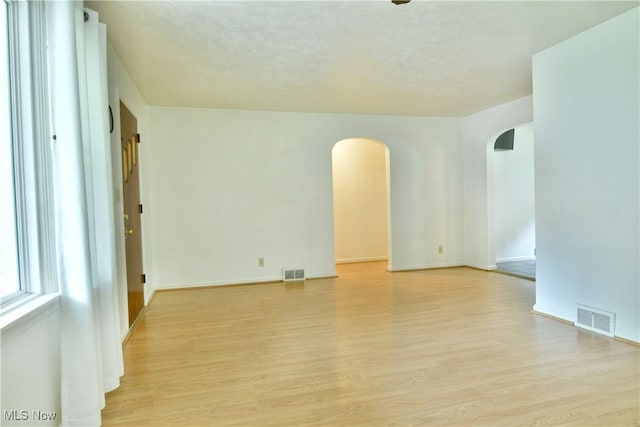 131 Euclid Blvd, Youngstown, OH 44505 - spare room with arched walkways, light wood-style floors, and a textured ceiling