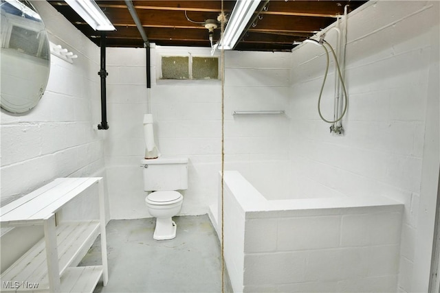 131 Euclid Blvd, Youngstown, OH 44505 - bathroom featuring concrete flooring, concrete block wall, and washtub / shower combination