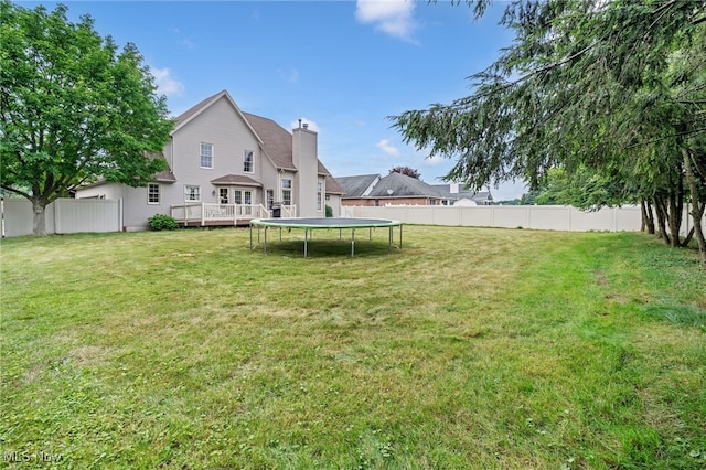 1133 S Azalea Blvd, Barberton, OH 44203 - view of yard featuring a trampoline and a wooden deck