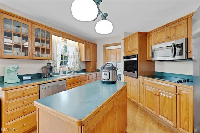 1133 S Azalea Blvd, Barberton, OH 44203 - kitchen featuring appliances with stainless steel finishes, glass insert cabinets, a kitchen island, and light wood-style floors