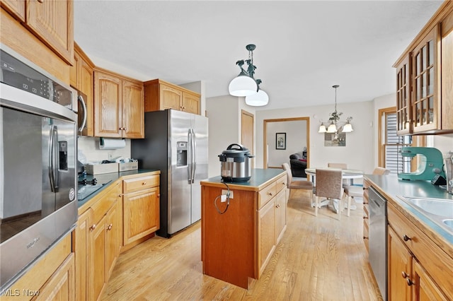 1133 S Azalea Blvd, Barberton, OH 44203 - kitchen with stainless steel appliances, a center island, light wood-style floors, and glass insert cabinets
