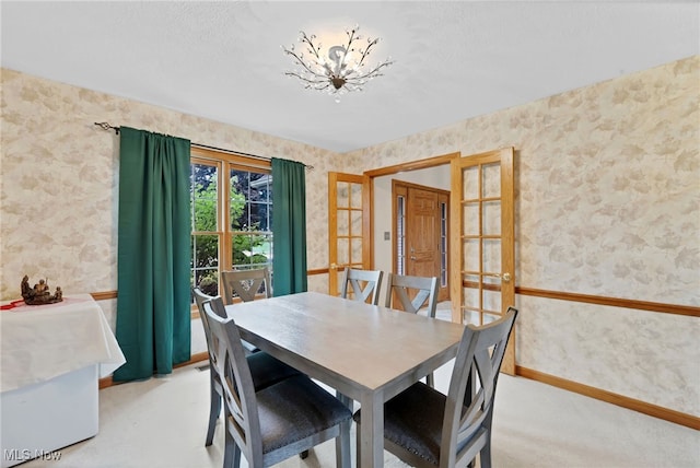 1133 S Azalea Blvd, Barberton, OH 44203 - dining area with wallpapered walls, a chandelier, and light colored carpet