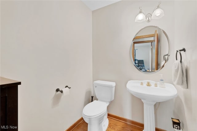 1133 S Azalea Blvd, Barberton, OH 44203 - half bathroom featuring toilet and wood finished floors