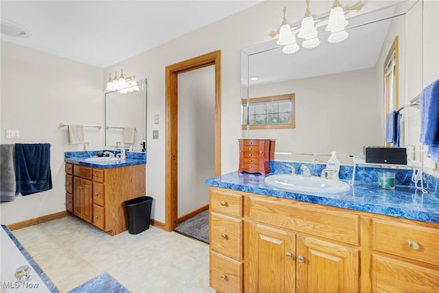 1133 S Azalea Blvd, Barberton, OH 44203 - bathroom featuring two vanities and baseboards
