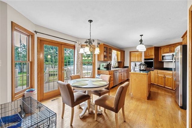 1133 S Azalea Blvd, Barberton, OH 44203 - dining area featuring a chandelier, light wood-style flooring, and washer / dryer