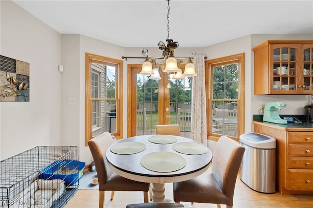 1133 S Azalea Blvd, Barberton, OH 44203 - dining space with a chandelier, healthy amount of natural light, and light wood-type flooring