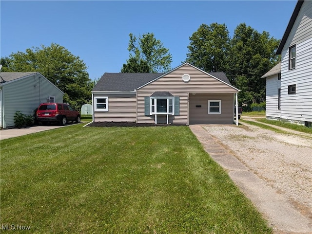 1240 W 21st St, Lorain, OH 44052 - view of front of home featuring a front yard, driveway, and roof with shingles