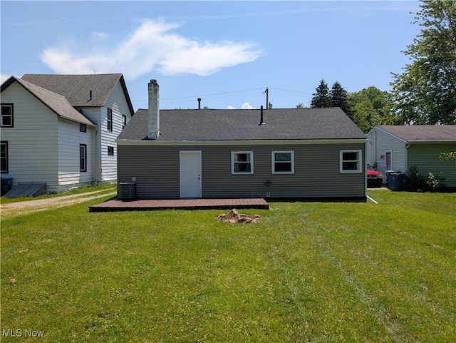 1240 W 21st St, Lorain, OH 44052 - back of property featuring a deck, a lawn, and a chimney