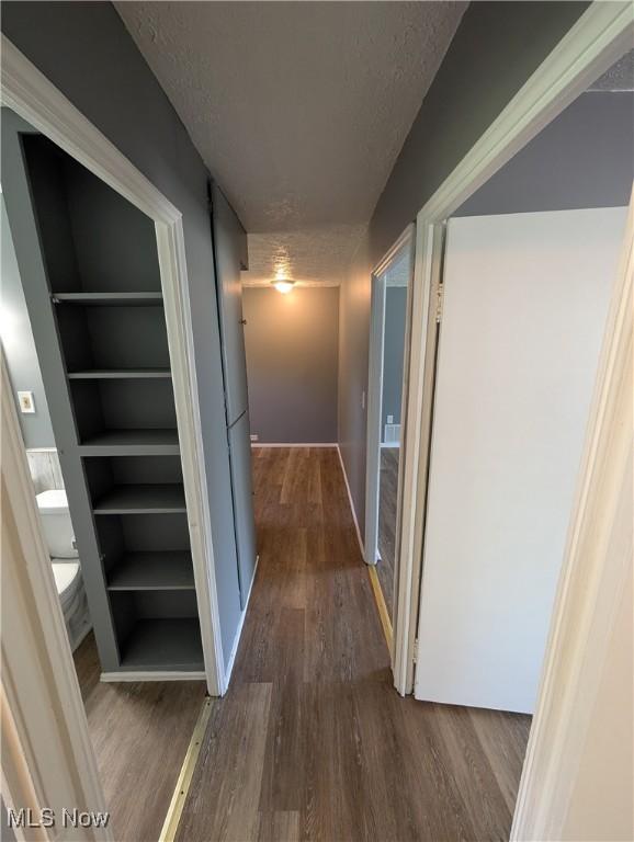 1240 W 21st St, Lorain, OH 44052 - hall featuring a textured ceiling and wood finished floors
