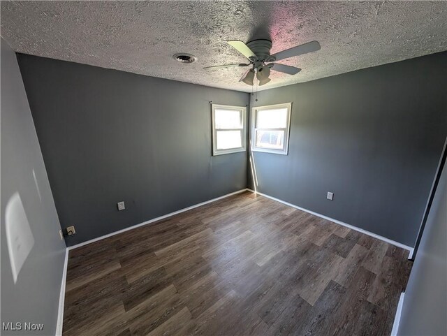 1240 W 21st St, Lorain, OH 44052 - empty room with dark wood-style flooring, ceiling fan, and a textured ceiling