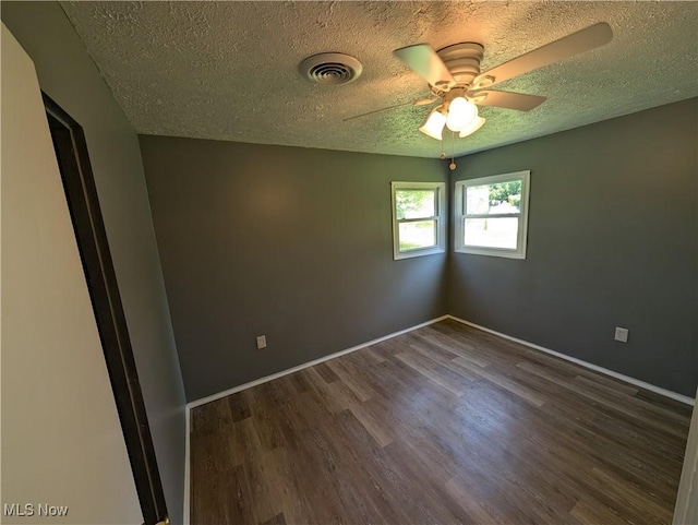 1240 W 21st St, Lorain, OH 44052 - empty room with a textured ceiling, a ceiling fan, and dark wood finished floors