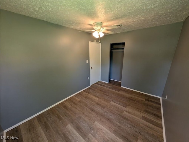 1240 W 21st St, Lorain, OH 44052 - unfurnished bedroom featuring a textured ceiling, wood finished floors, a closet, and a ceiling fan