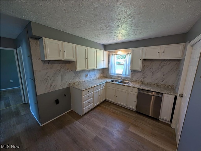 1240 W 21st St, Lorain, OH 44052 - kitchen with dishwasher, dark wood finished floors, white cabinetry, a textured ceiling, and tasteful backsplash
