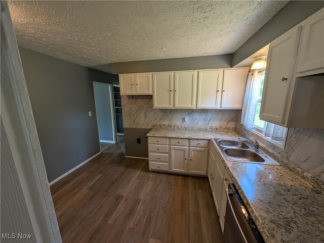1240 W 21st St, Lorain, OH 44052 - kitchen with dark wood-type flooring, a textured ceiling, decorative backsplash, dishwasher, and white cabinetry