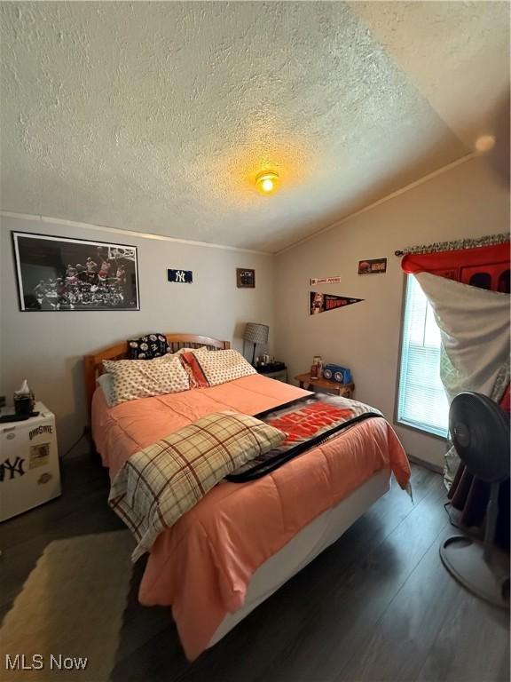 3925 N Ridge E, Ashtabula, OH 44004 - bedroom with a textured ceiling, lofted ceiling, and wood finished floors