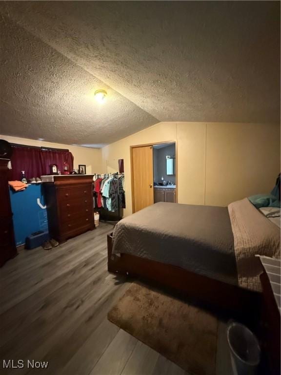 3925 N Ridge E, Ashtabula, OH 44004 - bedroom featuring wood finished floors, a textured ceiling, and lofted ceiling