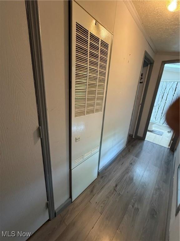3925 N Ridge E, Ashtabula, OH 44004 - hall with a heating unit, ornamental molding, wood finished floors, and a textured ceiling