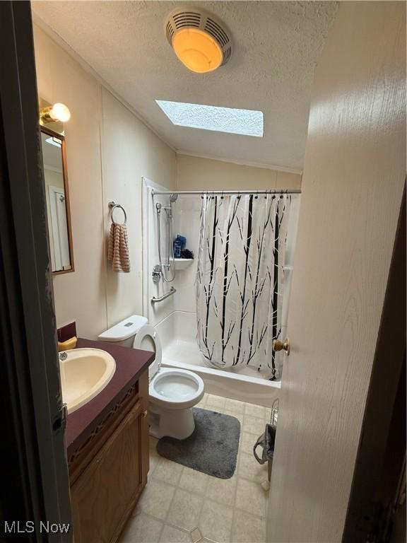 3925 N Ridge E, Ashtabula, OH 44004 - full bathroom with a skylight, vanity, shower / bathtub combination with curtain, a textured ceiling, and vaulted ceiling