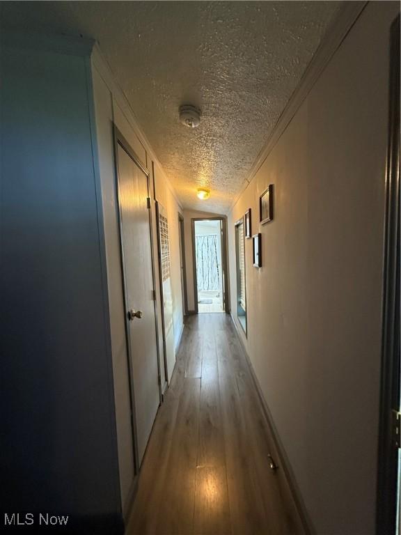 3925 N Ridge E, Ashtabula, OH 44004 - hallway featuring a textured ceiling, crown molding, and light wood-type flooring