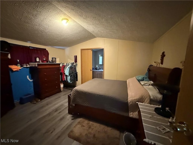 3925 N Ridge E, Ashtabula, OH 44004 - bedroom featuring wood finished floors, a textured ceiling, and lofted ceiling