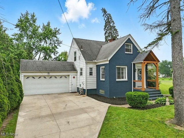 1624 Krumroy Rd, Akron, OH 44306 - view of front of home with concrete driveway, an attached garage, a front lawn, a chimney, and a shingled roof