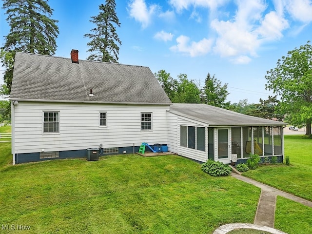 1624 Krumroy Rd, Akron, OH 44306 - rear view of house featuring a sunroom, a chimney, a lawn, and a shingled roof
