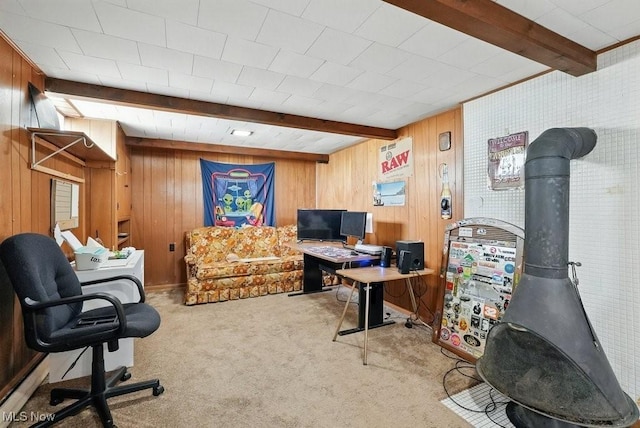 1624 Krumroy Rd, Akron, OH 44306 - carpeted home office featuring beam ceiling, wooden walls, and a wood stove