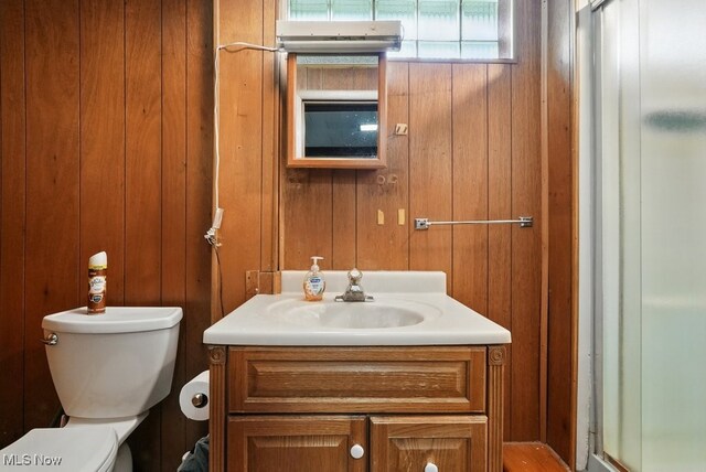 1624 Krumroy Rd, Akron, OH 44306 - bathroom featuring vanity, a shower stall, and wooden walls