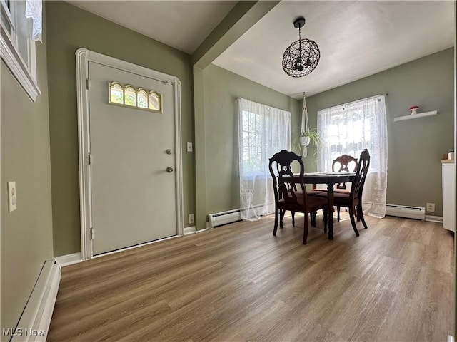 1624 Krumroy Rd, Akron, OH 44306 - dining area featuring a baseboard radiator, a chandelier, and wood finished floors
