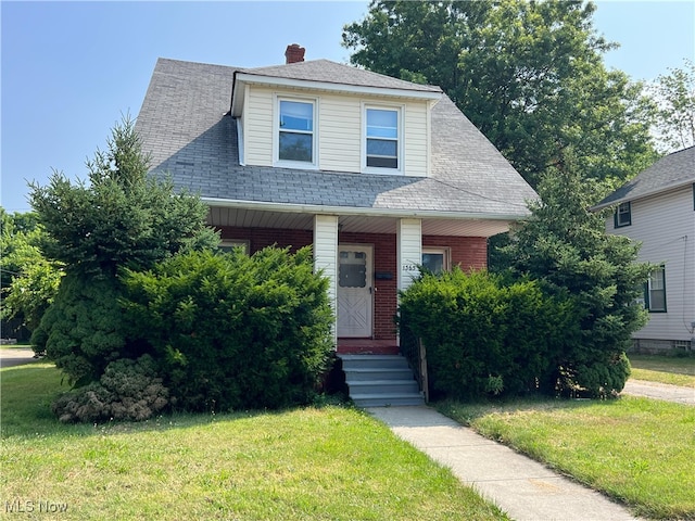 1365 Craneing Rd, Wickliffe, OH 44092 - view of front facade featuring a front yard, a porch, and a shingled roof