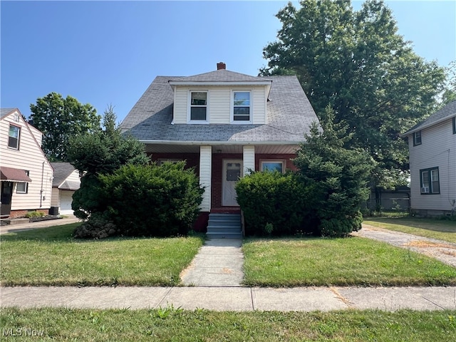 1365 Craneing Rd, Wickliffe, OH 44092 - view of front of property featuring a front lawn, a porch, roof with shingles, and a chimney