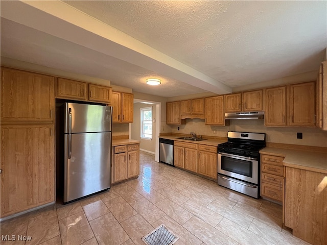 1365 Craneing Rd, Wickliffe, OH 44092 - kitchen featuring appliances with stainless steel finishes, under cabinet range hood, light countertops, a textured ceiling, and brown cabinetry