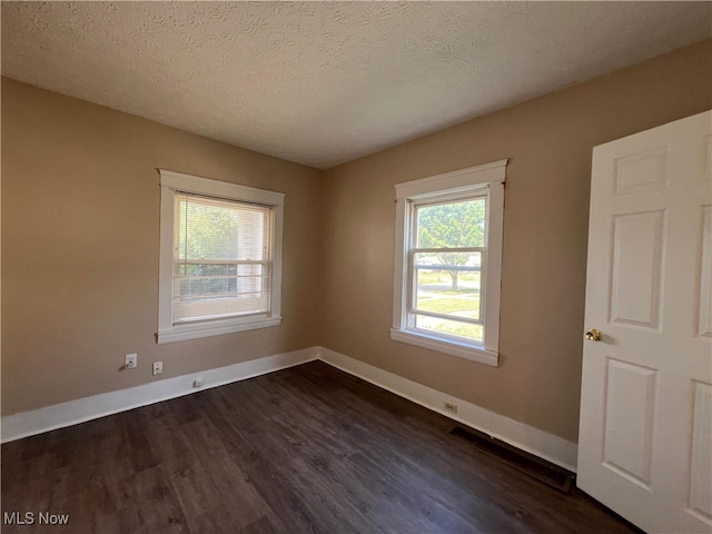 1365 Craneing Rd, Wickliffe, OH 44092 - spare room featuring dark wood-style flooring and a textured ceiling