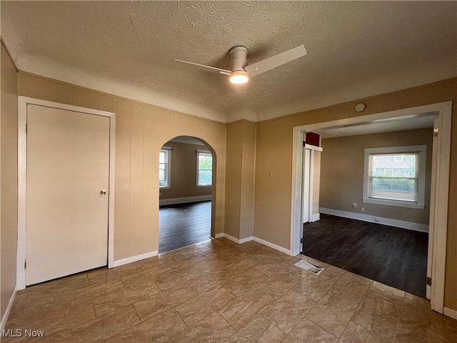 1365 Craneing Rd, Wickliffe, OH 44092 - spare room featuring ceiling fan, arched walkways, and a textured ceiling