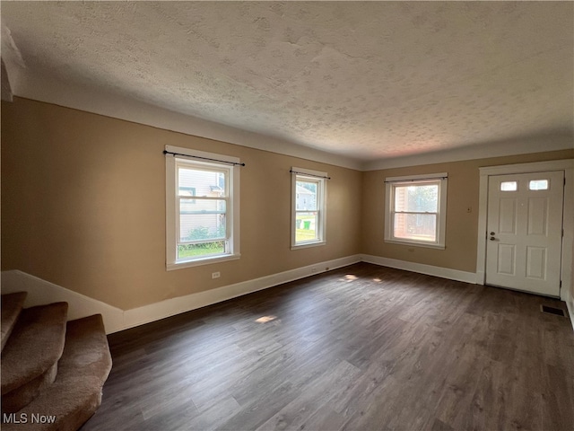 1365 Craneing Rd, Wickliffe, OH 44092 - unfurnished living room featuring a textured ceiling and dark wood-style floors