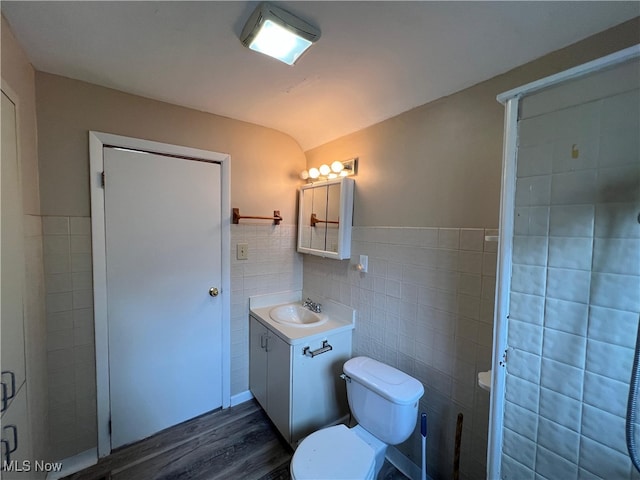 1365 Craneing Rd, Wickliffe, OH 44092 - bathroom with tile walls, vanity, wood finished floors, a shower with door, and a wainscoted wall